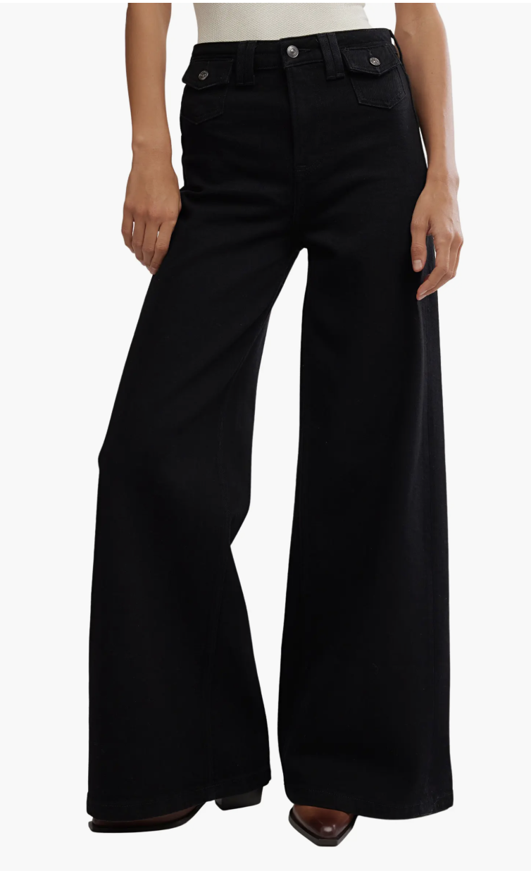 A product shot of the Free People Kellee High Waist Stretch Denim Palazzo Jeans in a dark wash, an editor-recommended choice for creating a polished and elongated silhouette.