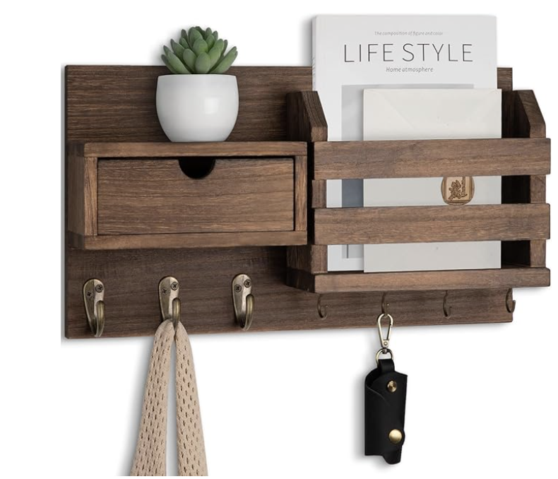 Wall-mounted mail sorter with hooks in a small apartment entryway