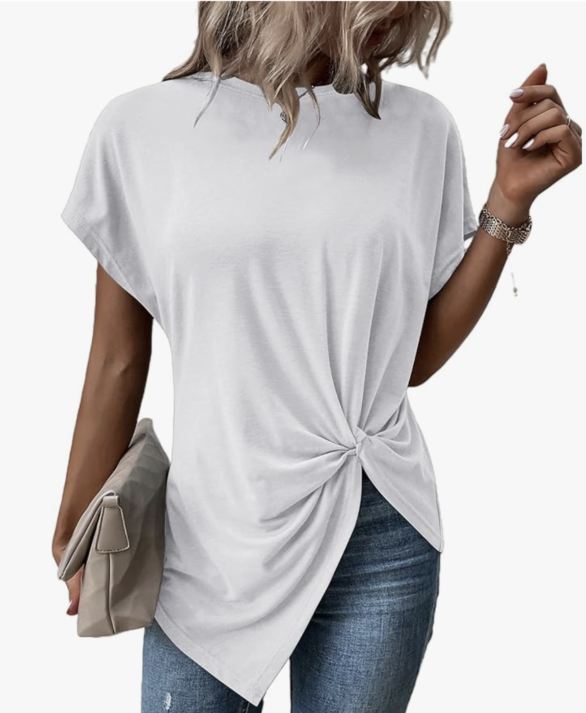 A woman wearing a white Twist Front Top Crewneck paired with jeans and a beige clutch, demonstrating a modern take on the perfect white tee for an understated luxury look.
