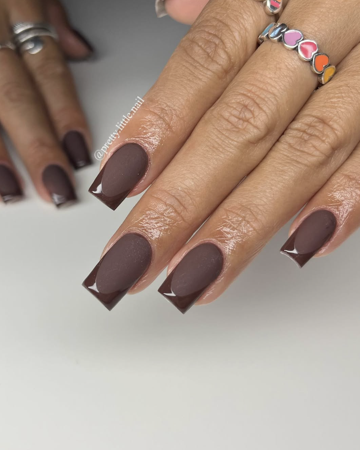 Short square nails painted matte dark chocolate brown.
