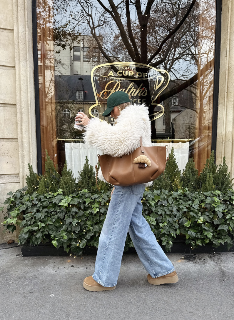 White fluffy jacket with light-wash wide-leg jeans, chestnut platforms and a tan shoulder bag.