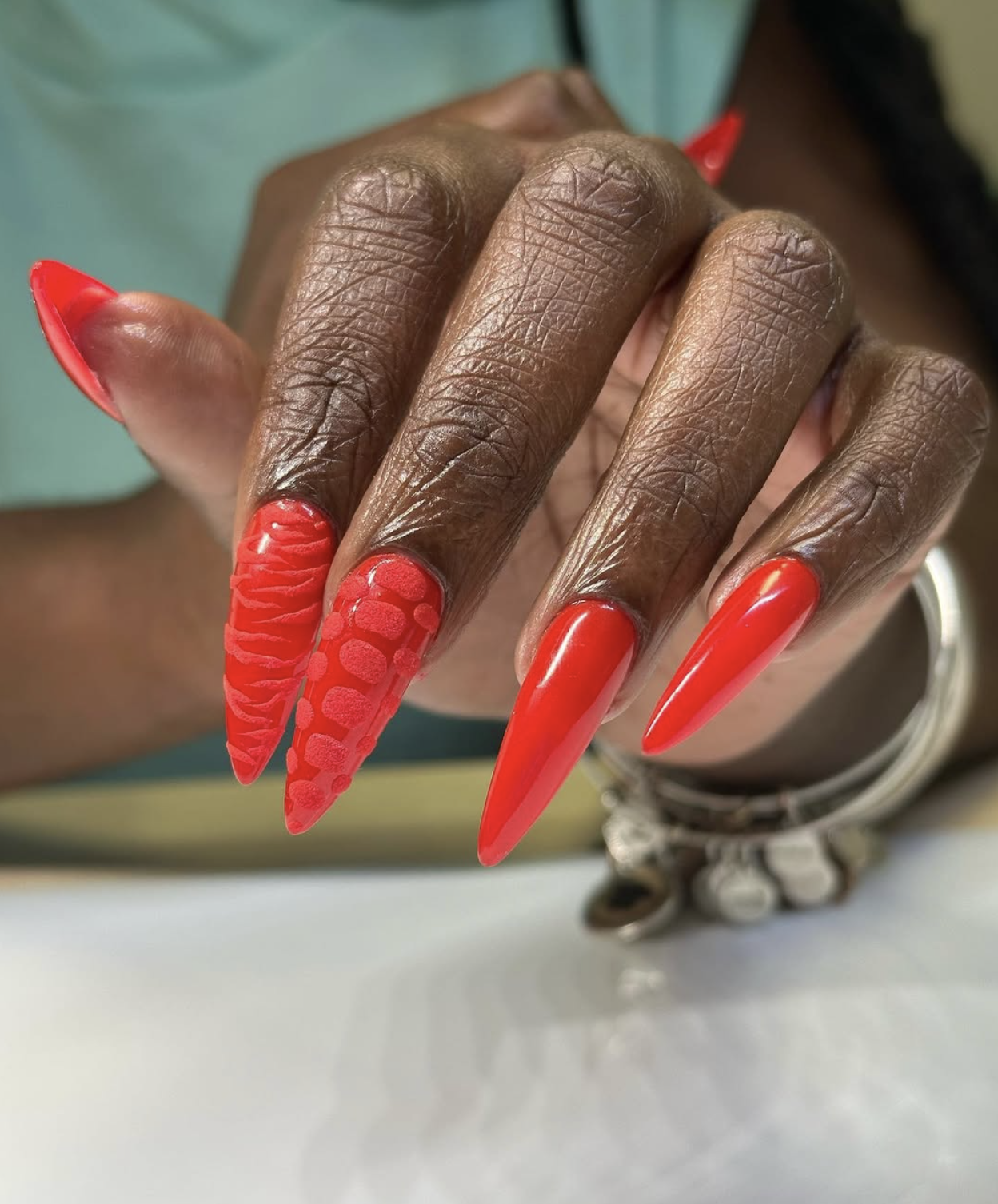Mixed red texture manicure with matte and glossy finishes