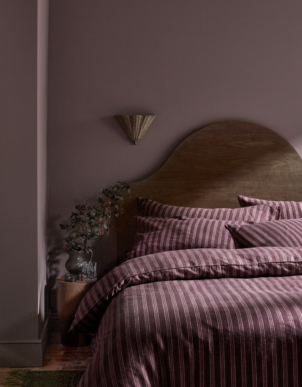Striped headboard and bedding used as a neutral bedroom pattern