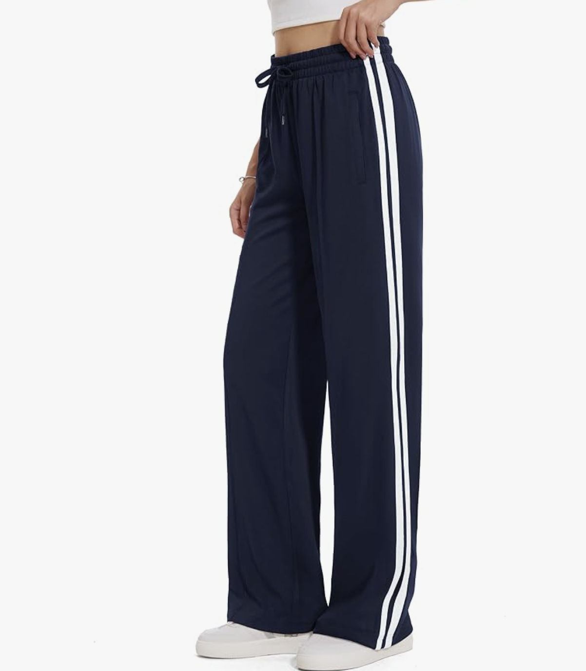Affordable style hack: Amazon Loose Straight Leg Track Pants in navy blue with white side stripes, featuring a high-waisted wide-leg silhouette for a comfortable and polished Sportif Luxe look.