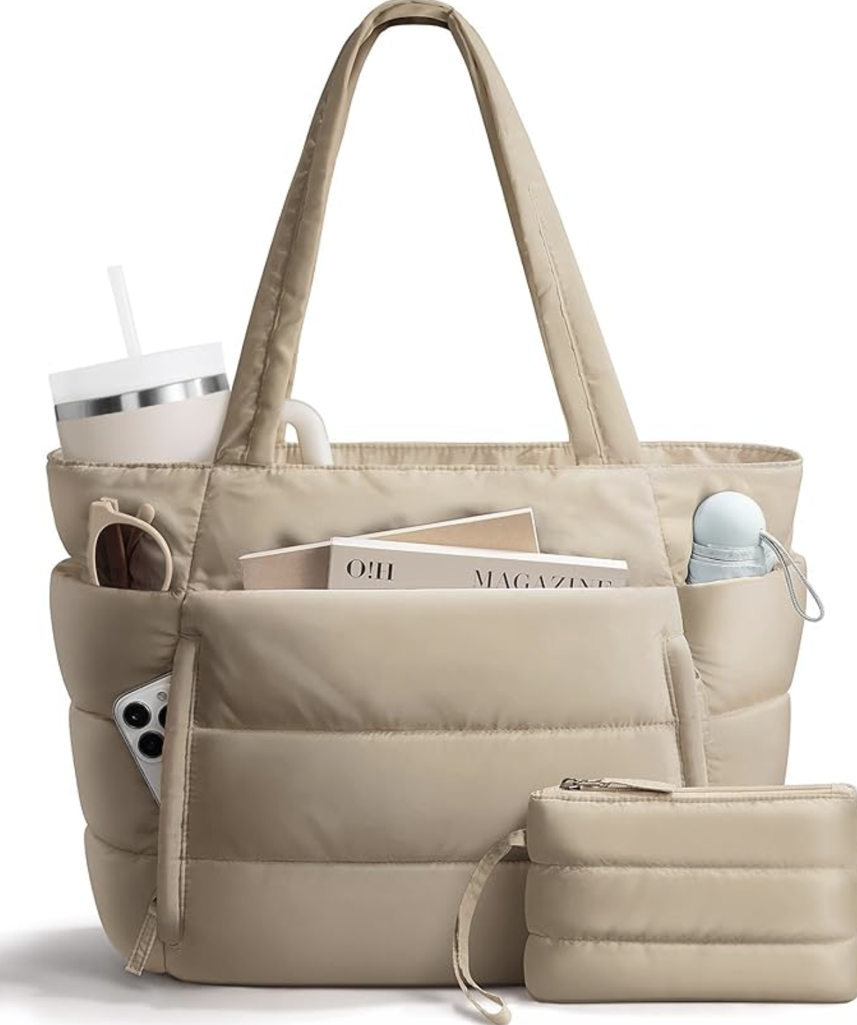 A beige quilted puffer tote bag from Amazon, organized with a laptop, a large white water bottle, and a magazine, shown in a cutout style with a transparent background.