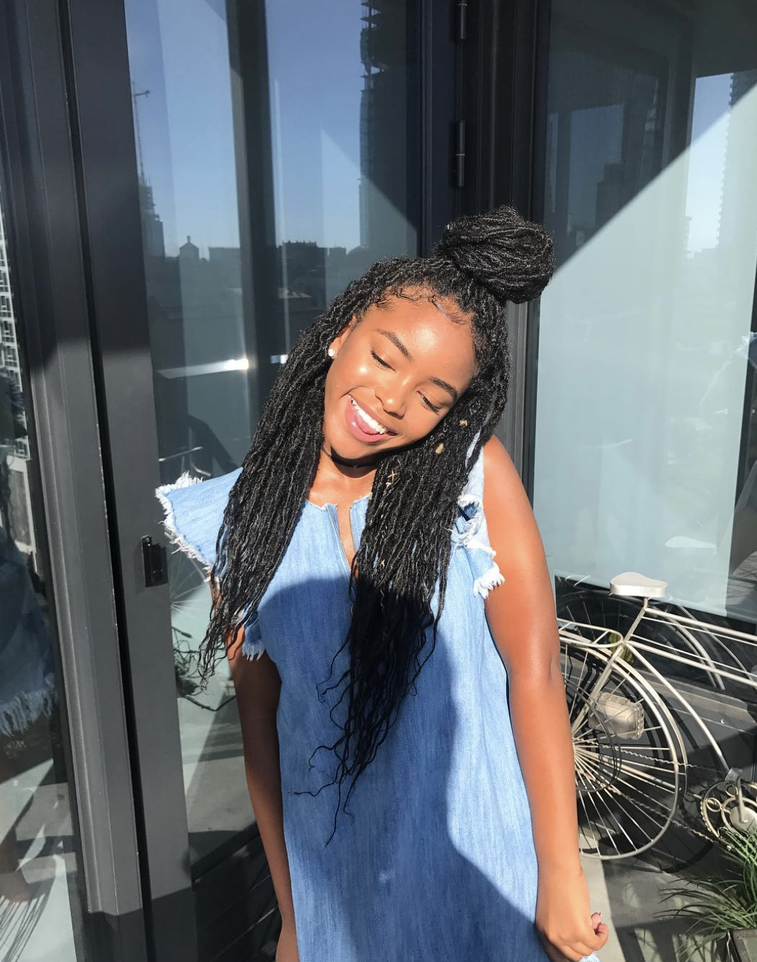 Lovie Simone wearing long, voluminous locs with a side part, styled to frame an oval face shape.