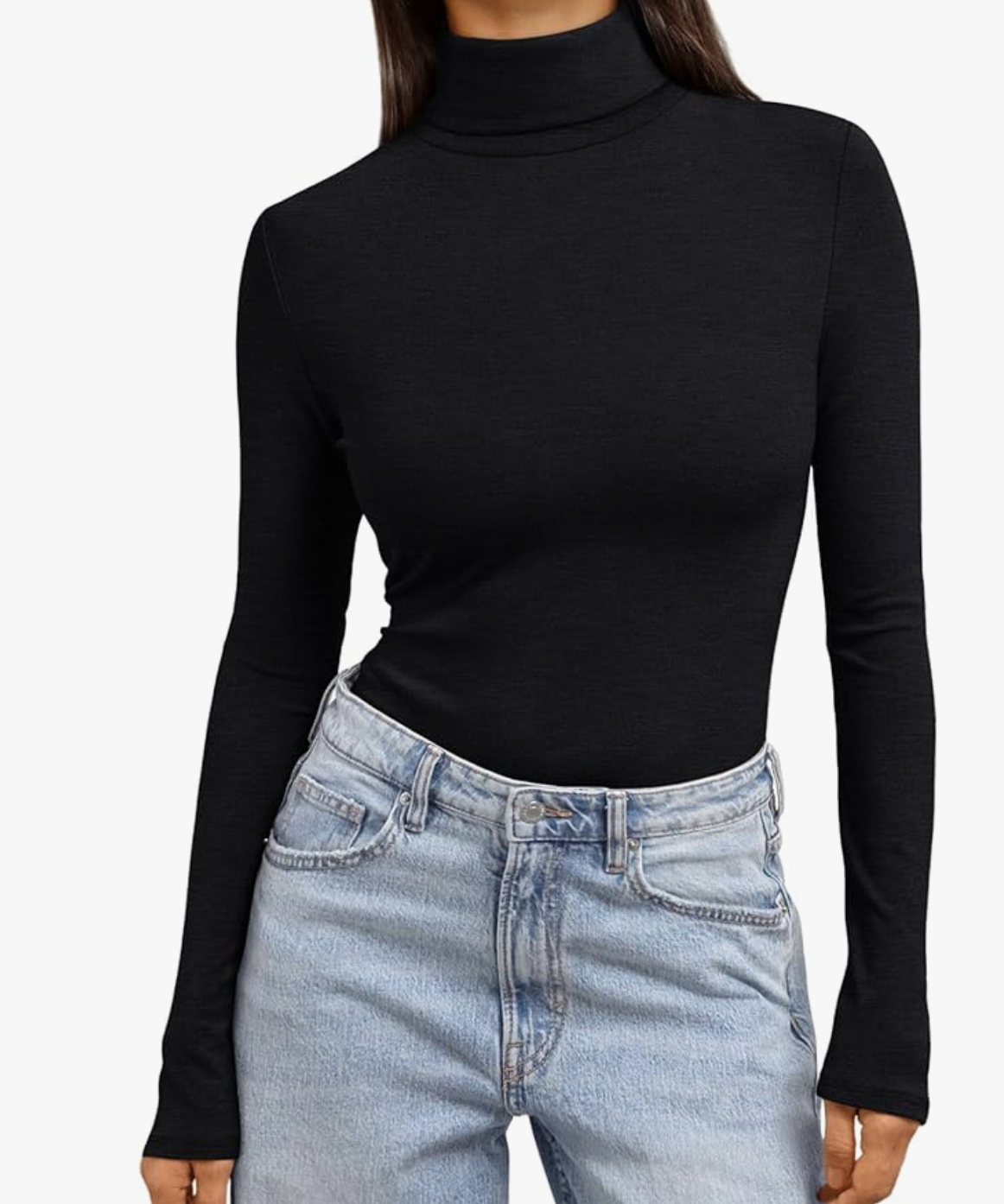 A close-up of a woman wearing a black long-sleeve fitted turtleneck tucked into light wash blue jeans with a black leather belt.