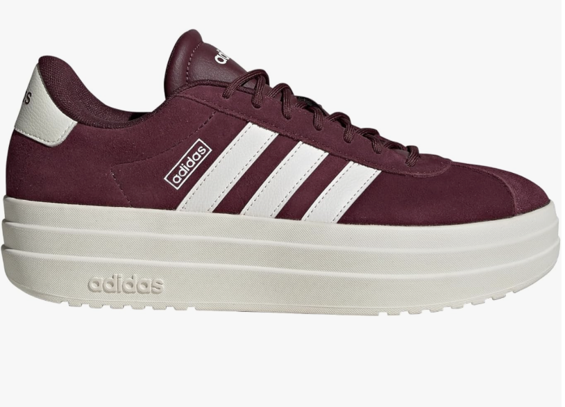 A side view of the Adidas Women's VL Court Bold sneakers in a deep maroon suede with white stripes and a thick cream platform sole, a stylish "New Neutral" footwear option for 2026.