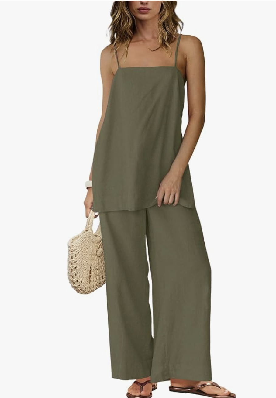 A close-up view of a relaxed summer outfit featuring an olive green linen square-neck tank top paired with matching high-waisted, wide-leg linen pants, styled with a woven straw handbag and brown flat sandals.