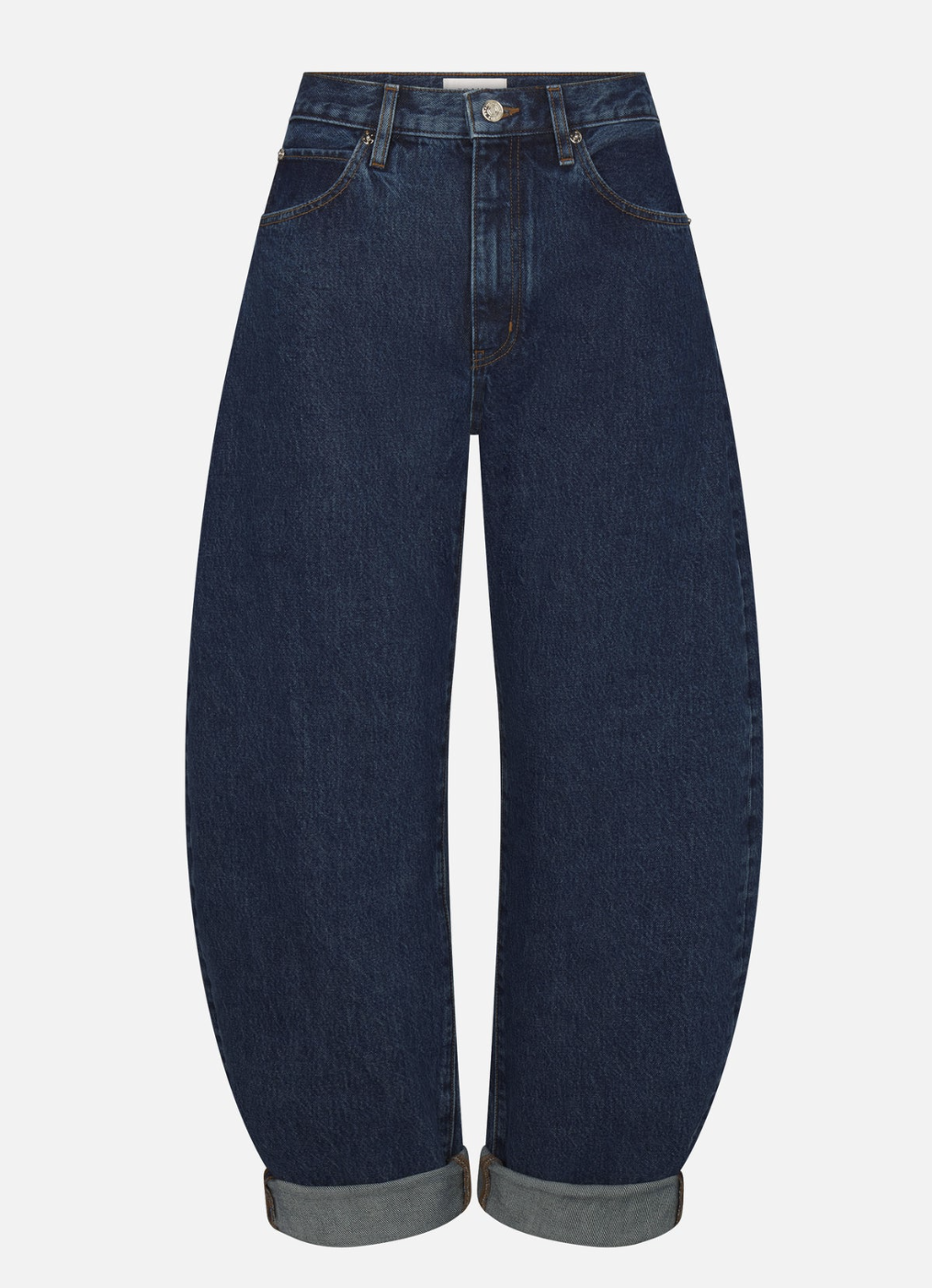 A person wearing high-waisted, dark-wash FRAME wide-leg jeans with wide cuffed hems.