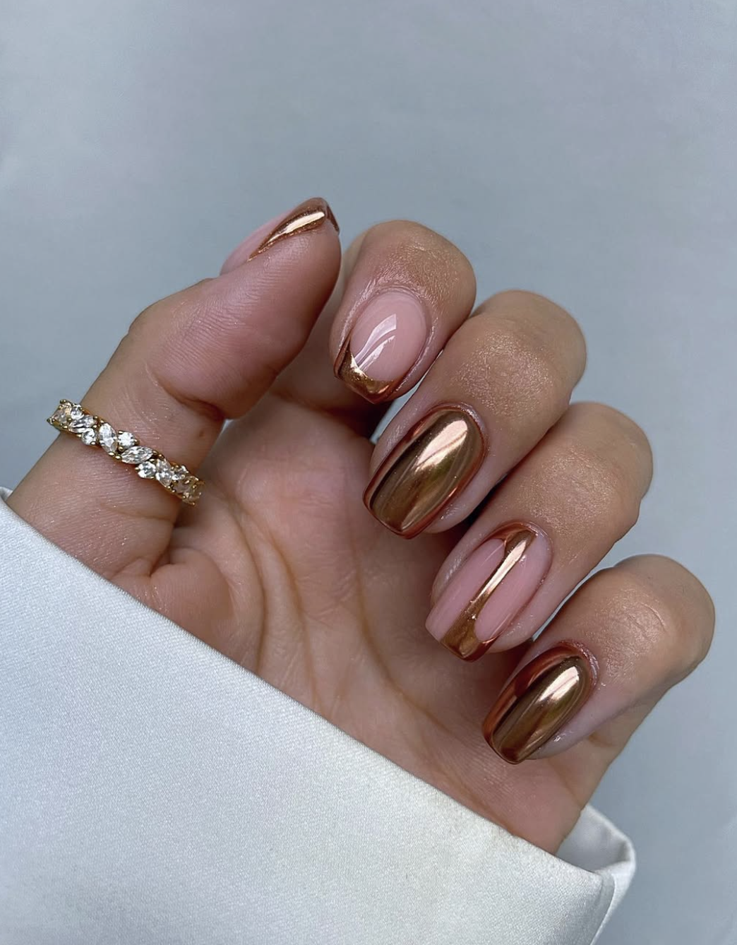 A close-up of dark chocolate brown nails featuring warm caramel accent nails detailed with 3D glossy droplet accents.