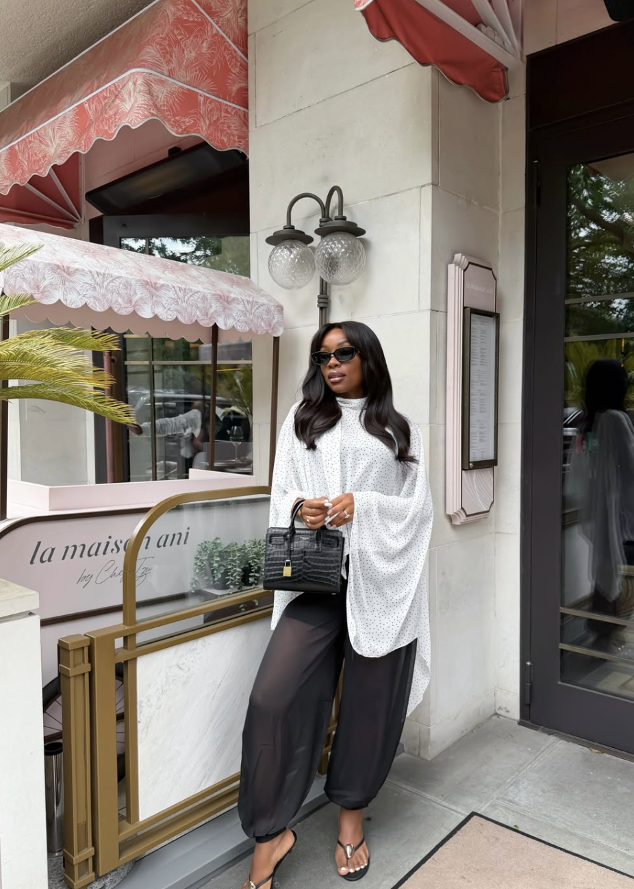 woman wearing a micro polka dot blouse as a summer outfit — small dots styled as texture not print