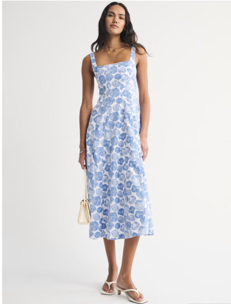 A woman modeling a light blue and white floral print midi dress from Abercrombie, featuring a square neckline, thick tank straps, a structured bodice, and an A-line skirt with a subtle tier.