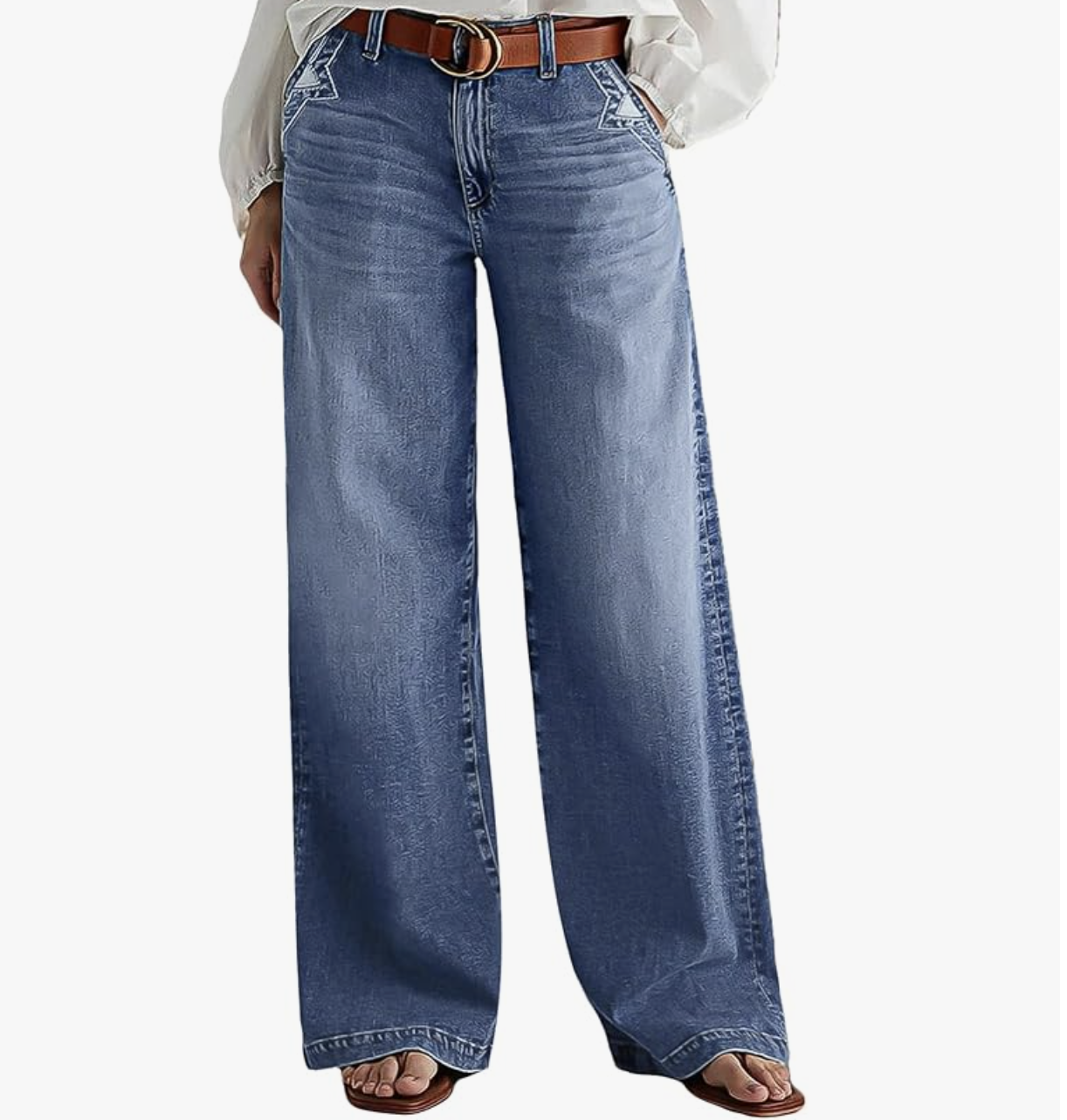 A woman wearing light-wash wide-leg baggy jeans with dark contrast stitching along the sides, styled as a modern denim trend for women in their 50s.