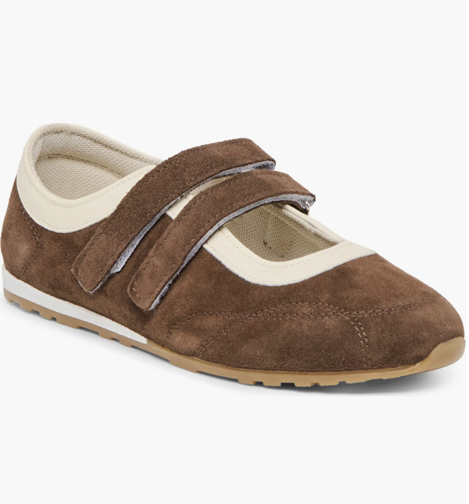 A tan suede Mary Jane sneaker for women by Dolce Vita, featuring a sporty rubber sole, a single strap with a white buckle, and a casual ballet flat silhouette.