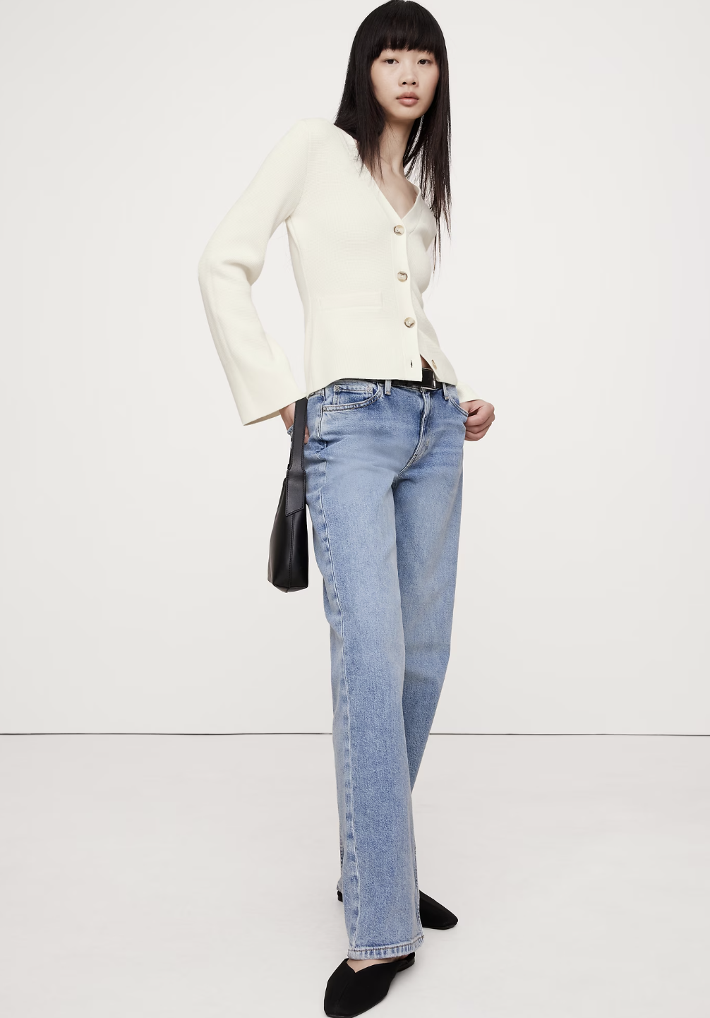 A woman wearing a dark burgundy Banana Republic Stretch-Cotton Barrel Midi Dress paired with black leather ankle boots.