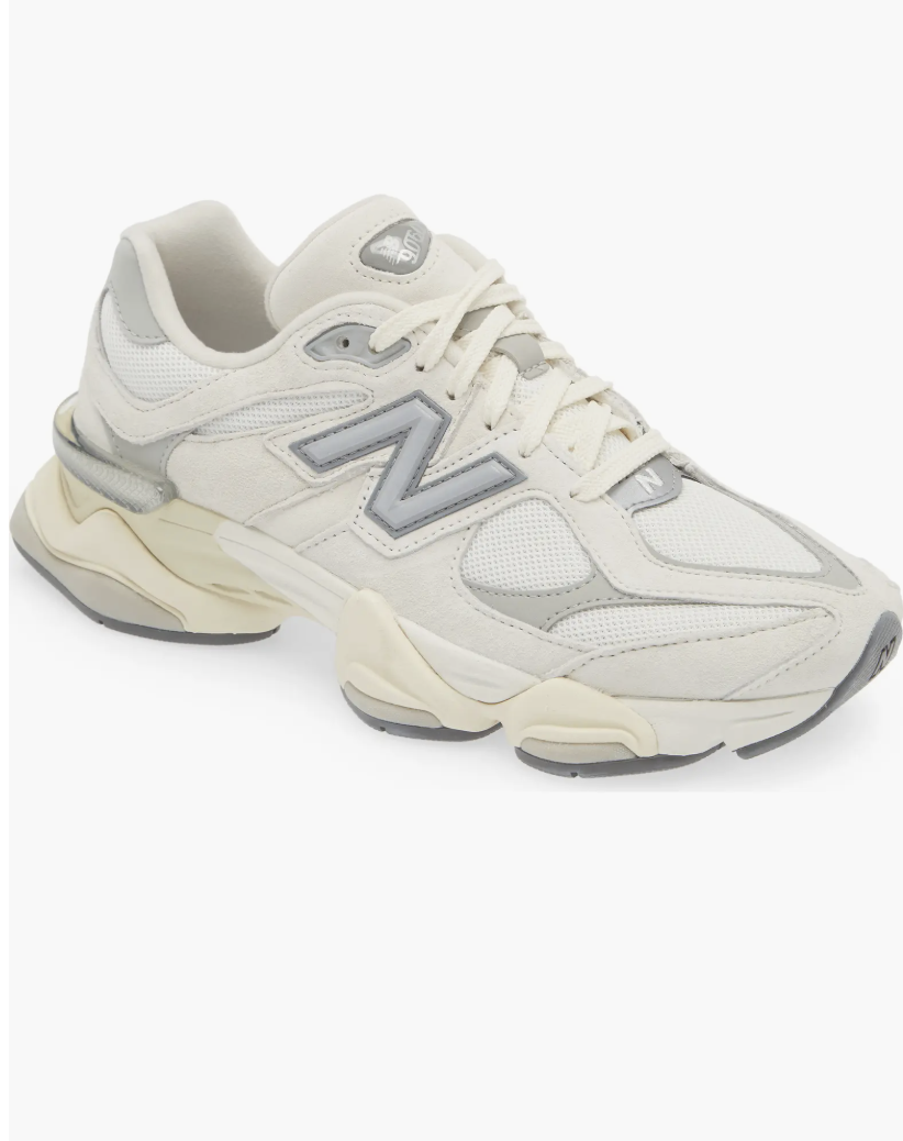 A pair of New Balance 9060 sneakers in a neutral cream and beige colorway.