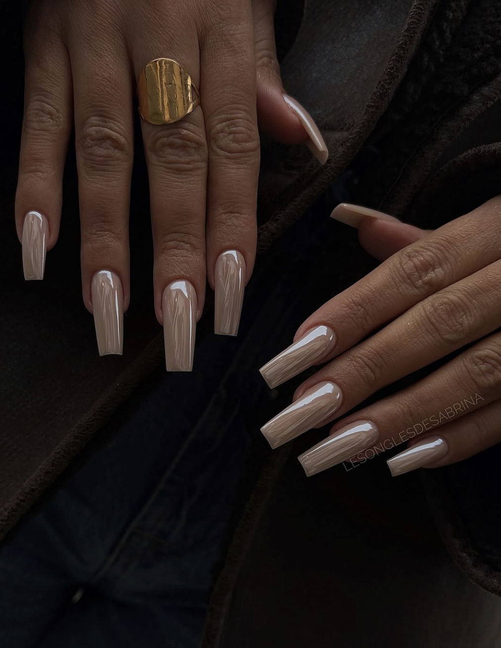 Healthy short natural nails with a sheer nude tint and high-gloss finish.