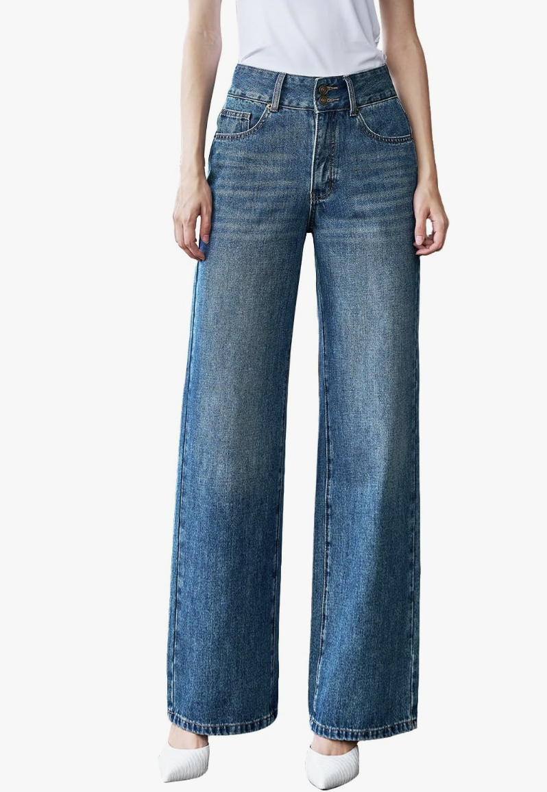 A close-up of a person wearing high-waisted, medium-wash straight-leg jeans from Amazon, styled with white pointed-toe heels.