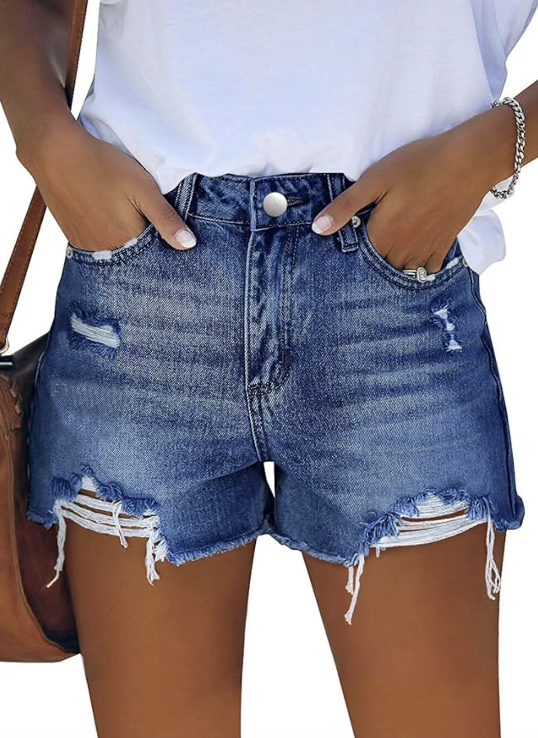 A pair of light-wash high-waisted distressed denim shorts with a frayed hem, styled for a polished summer outfit.