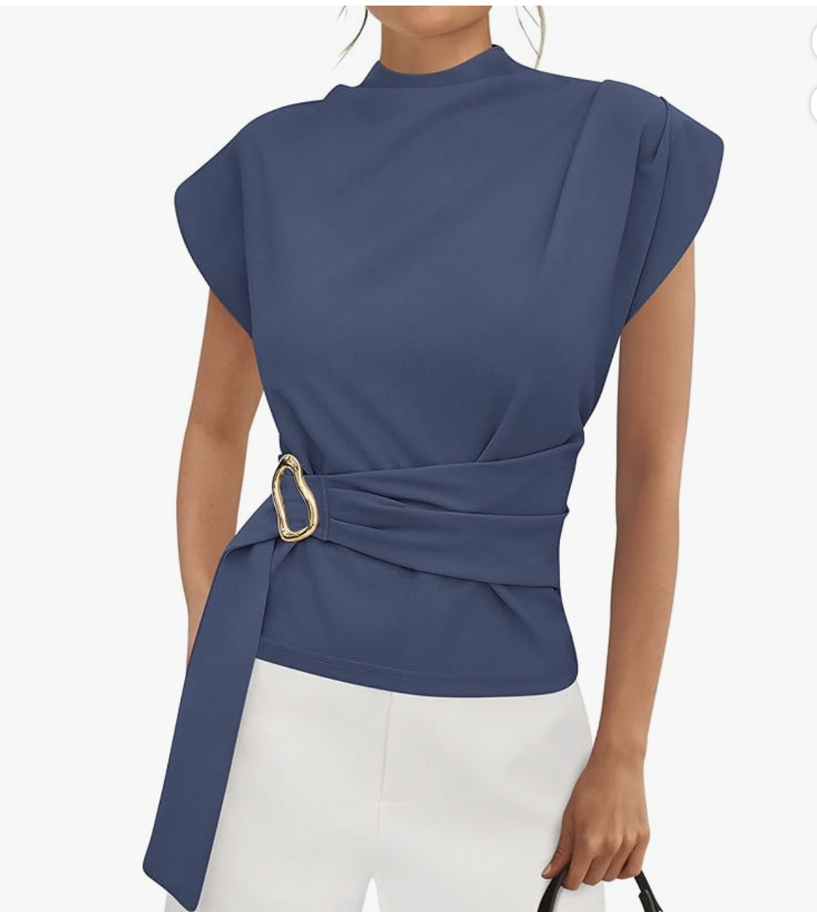 Close-up of a woman wearing a navy blue mock-neck tunic blouse featuring a wrap-style front and a gold organic-shaped buckle detail at the waist.