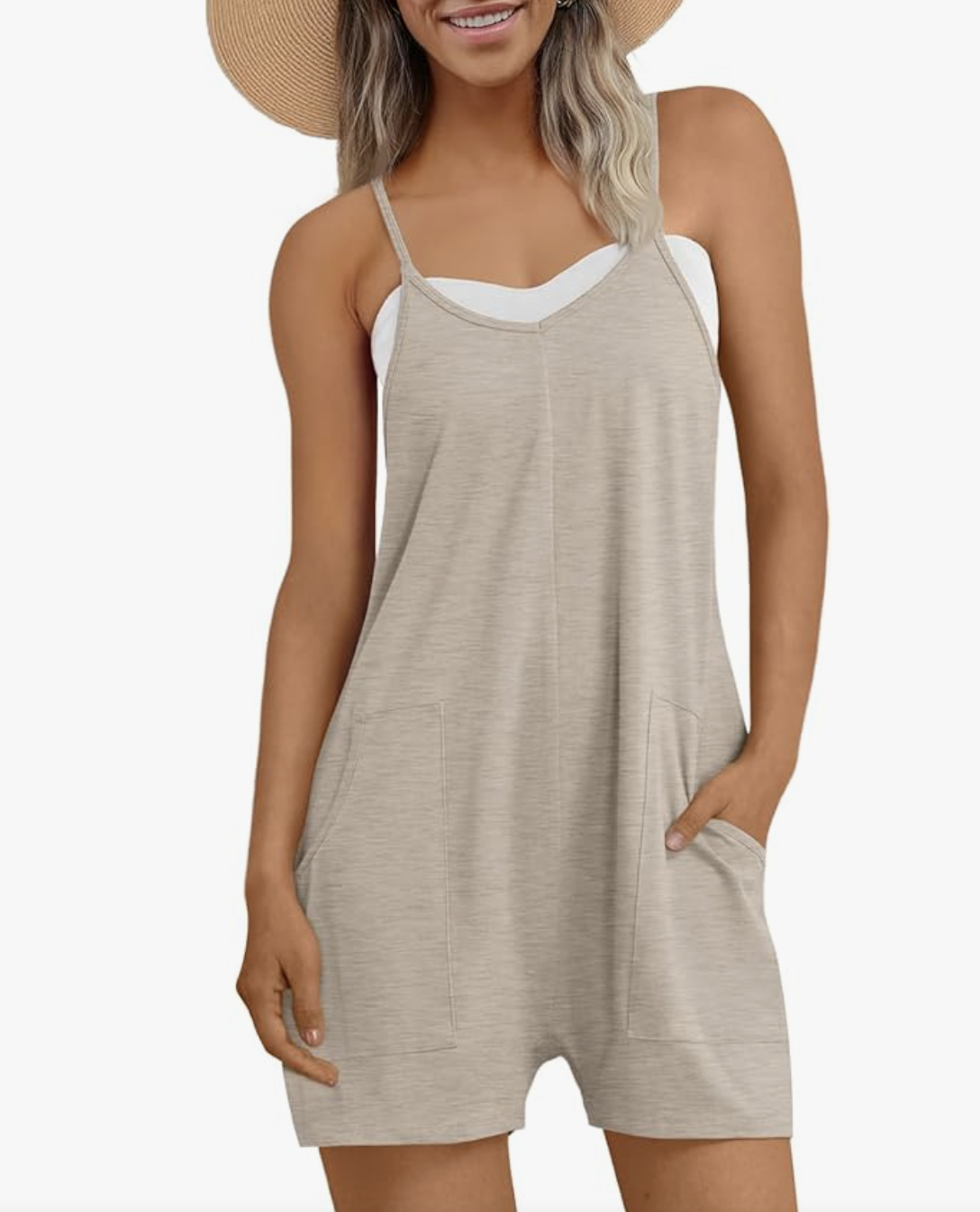 A woman wearing a sleeveless grey romper jumpsuit with pockets, styled for a casual summer BBQ outfit.