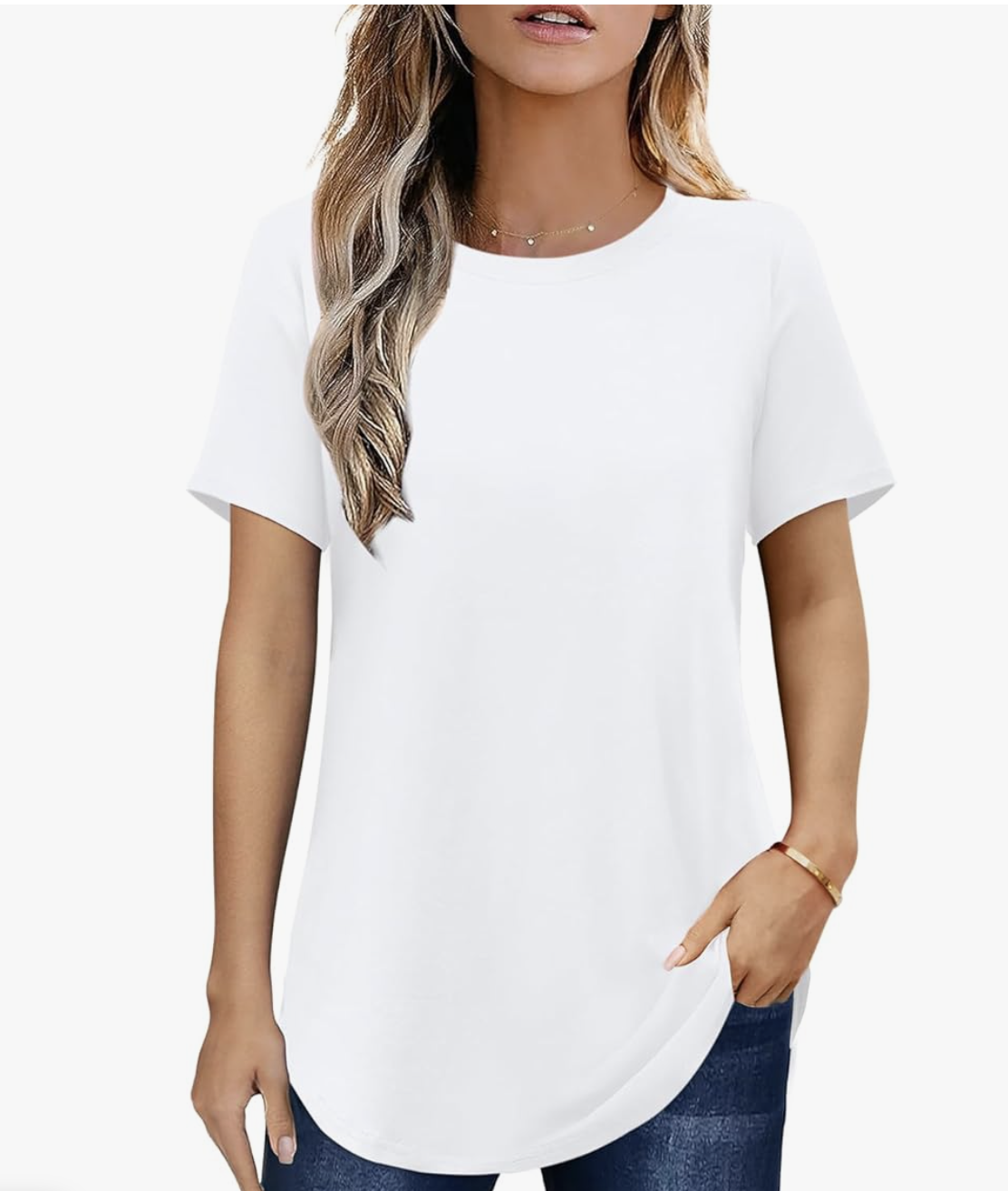 A product shot of a women's white tunic-style t-shirt with a curved hemline. This represents a high-quality mid-weight cotton staple used as a structural anchor for layering under oversized crewnecks or button-downs.