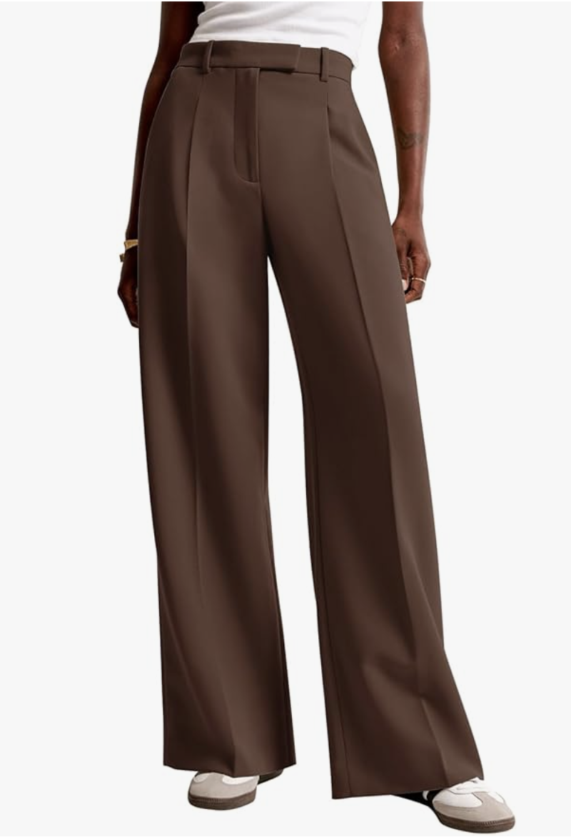 high-waisted pleated trousers styled with sneakers.