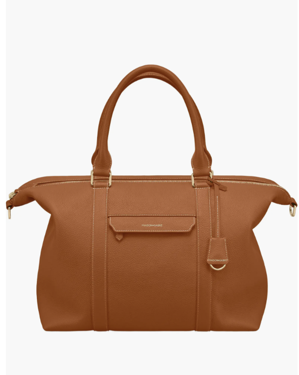 Full-grain leather weekender bag featuring a convertible luggage handle sleeve.