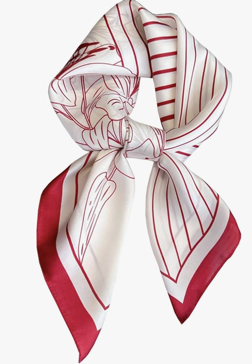 Close-up of a luxurious red and white floral patterned silk scarf, styled as a chic accessory for a 2026 outfit formula.