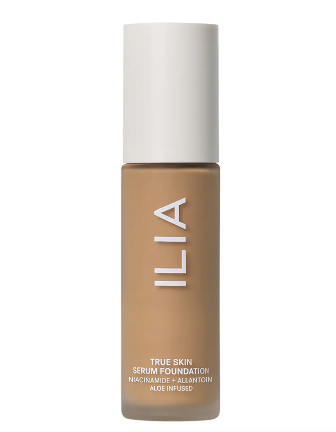A bottle of ILIA True Skin Serum Foundation in a medium tan shade against a clean white background.