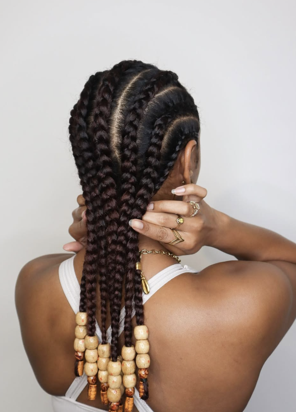 Straight-back cornrows featuring alternating small and large graduated braid rows.