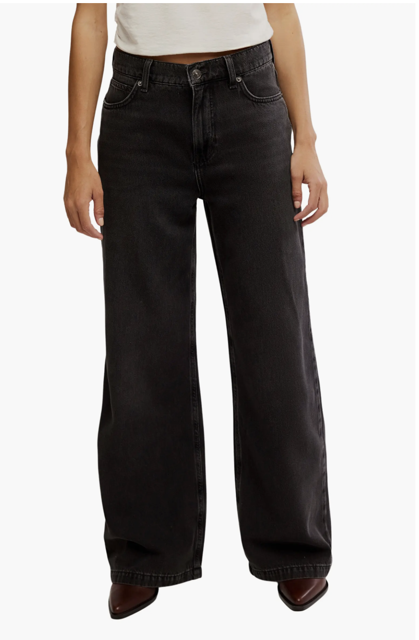 A product shot of the Free People Stride High Waist Wide Leg Jeans in a dark wash, an editor-recommended foundation for balancing pointed-toe boots and long coats.
