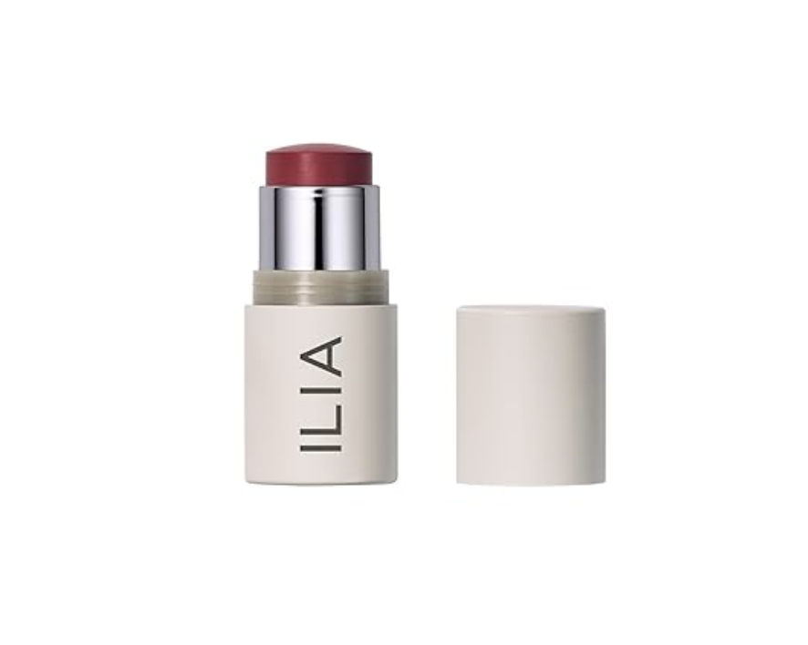 A close-up view of an ILIA Multi-Stick highlighter cream makeup tube shown open with its cap off against a clean white background.