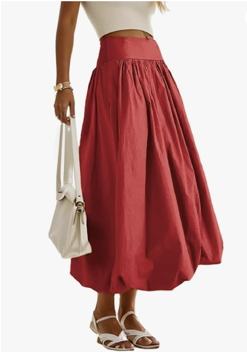 Fashion editor wearing a voluminous cherry red bubble maxi skirt with a fitted white top, demonstrating a 2026 romantic outfit formula.