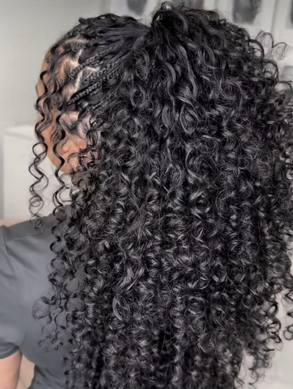 Long boho knotless braids with soft loose curls placed throughout the length.