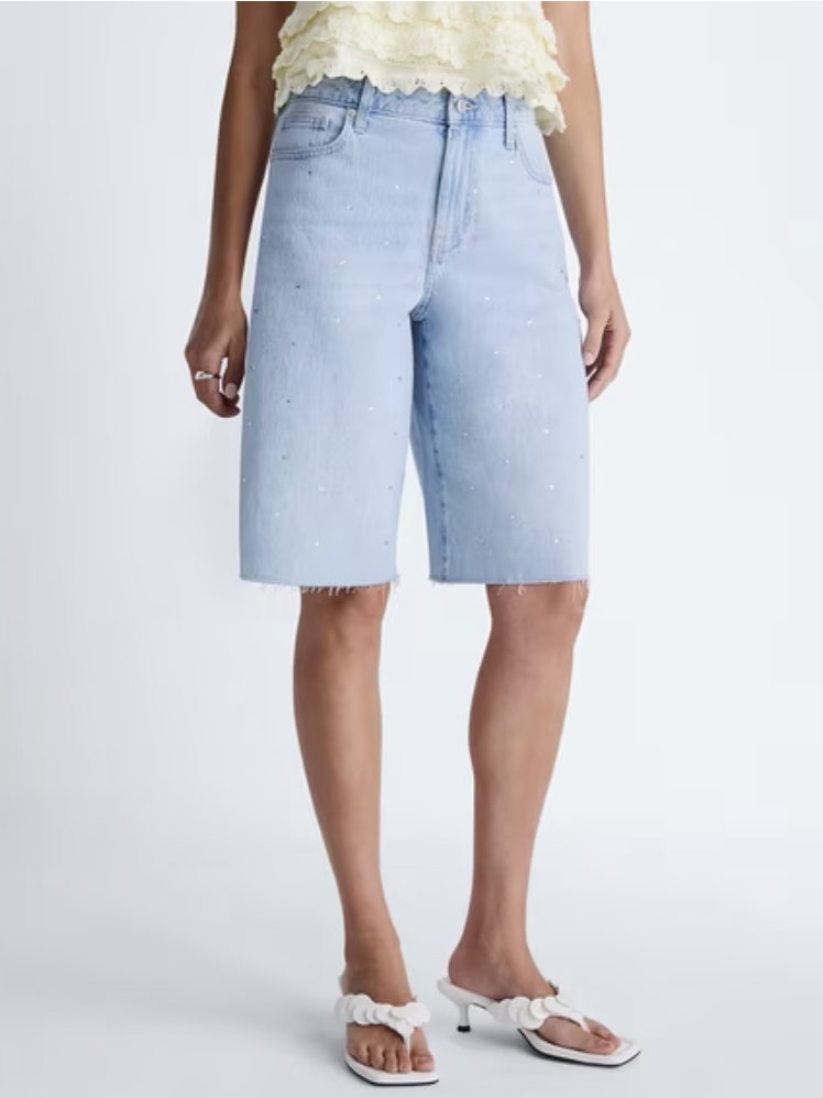 Classic denim Bermuda shorts with a raw hem and extended length.