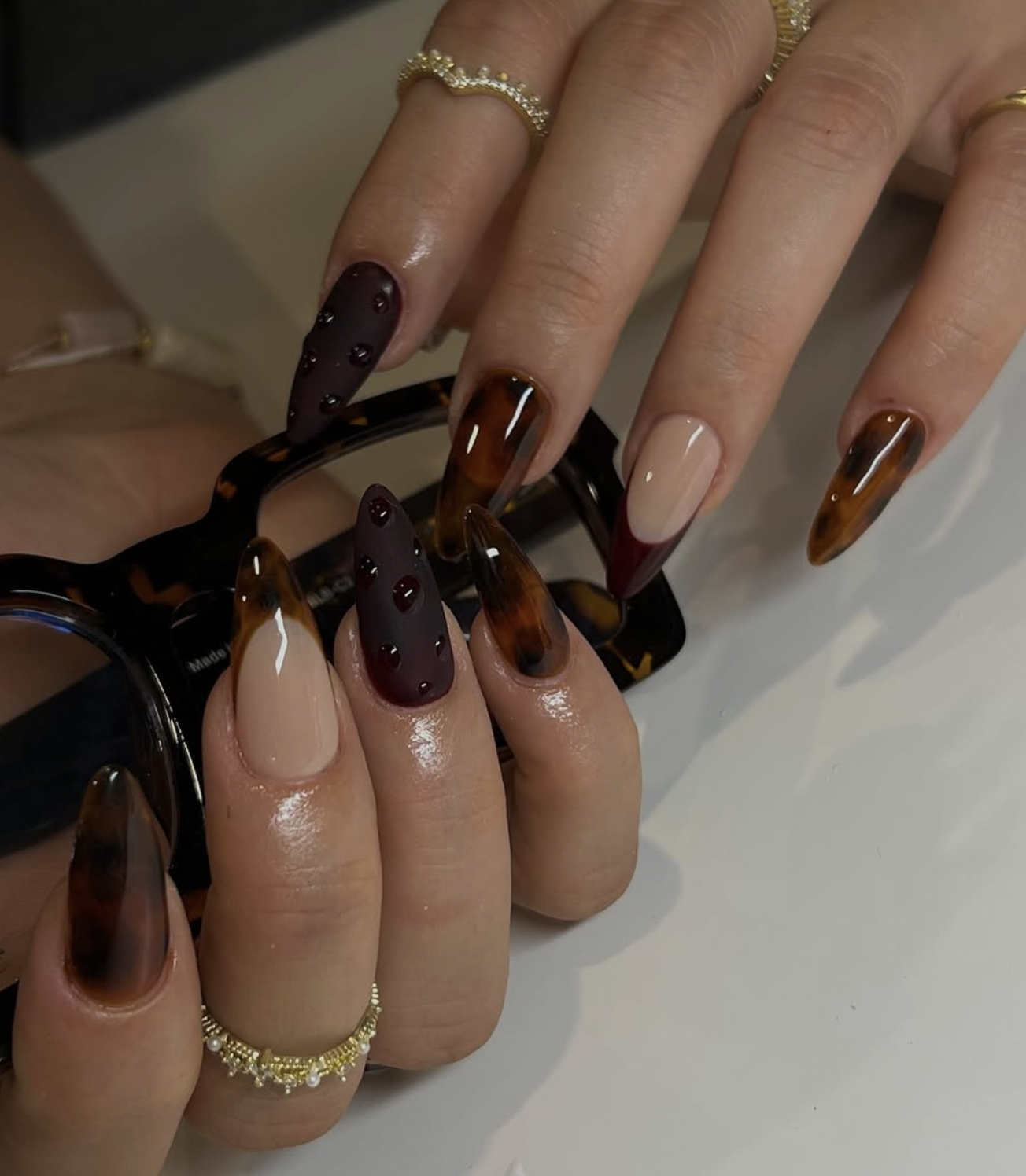 Amber and brown tortoiseshell accent nail design with espresso polish