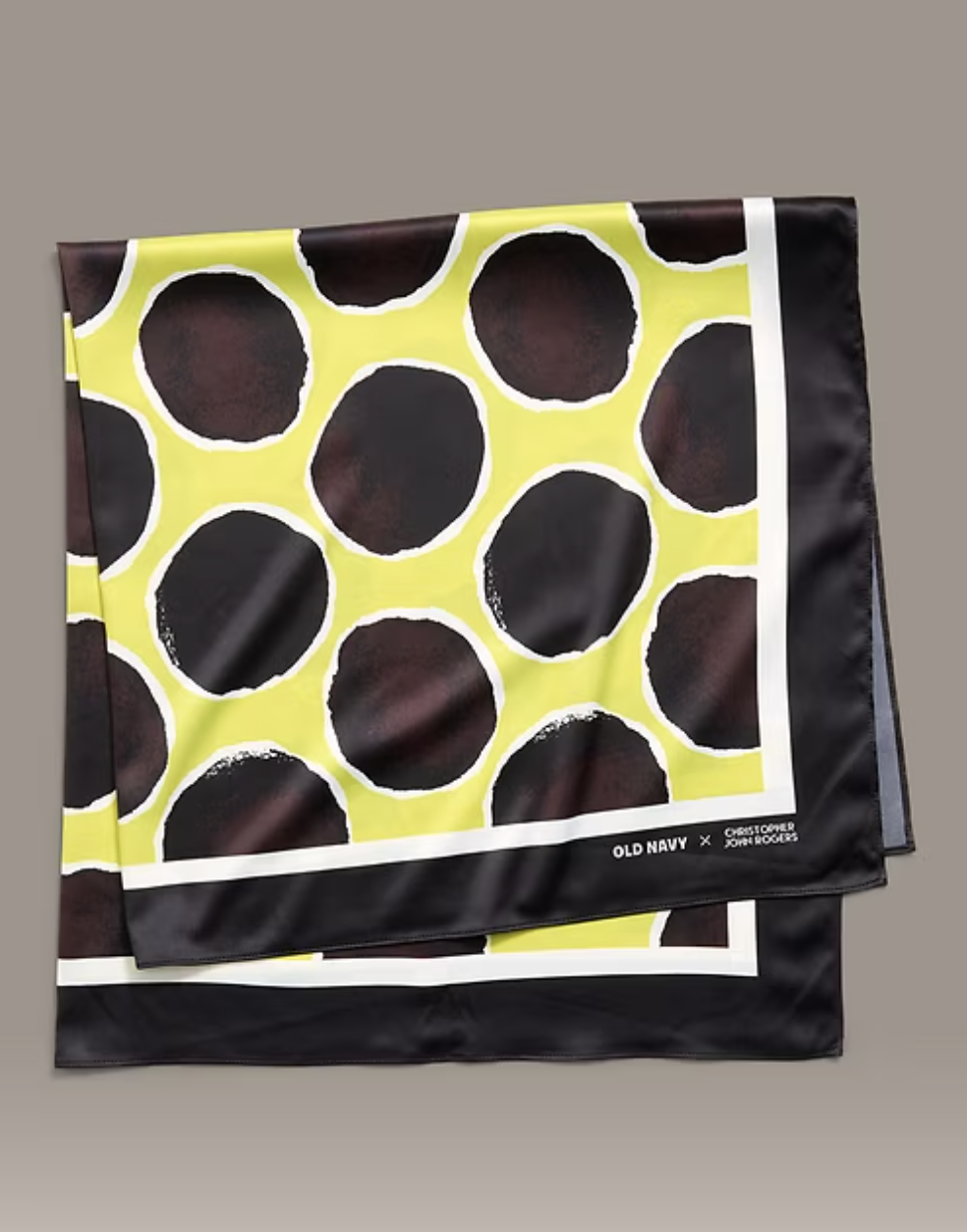 Folded Old Navy x Christopher John Rogers silk-style scarf featuring a bold black and yellow off-kilter polka dot print with a white border.