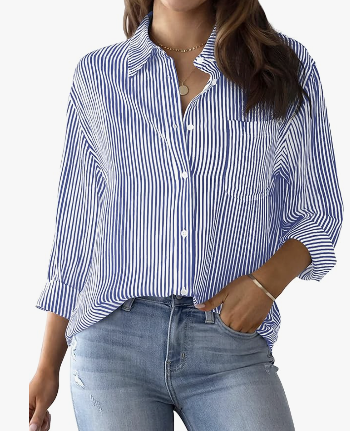 A close-up view of a person wearing a classic blue and white vertical striped long-sleeve button-down shirt tucked into light wash jeans.