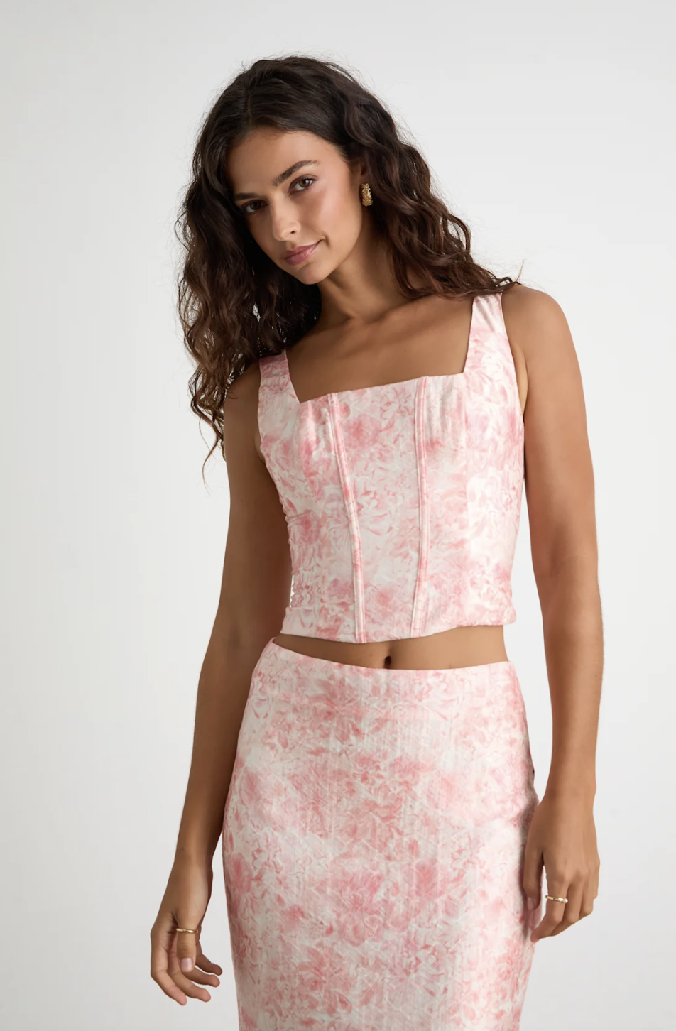 Model wearing the Lulus Lynelle Pink Floral Textured Sleeveless Bustier Top with matching skirt, showcasing the 2026 corset fashion trend.