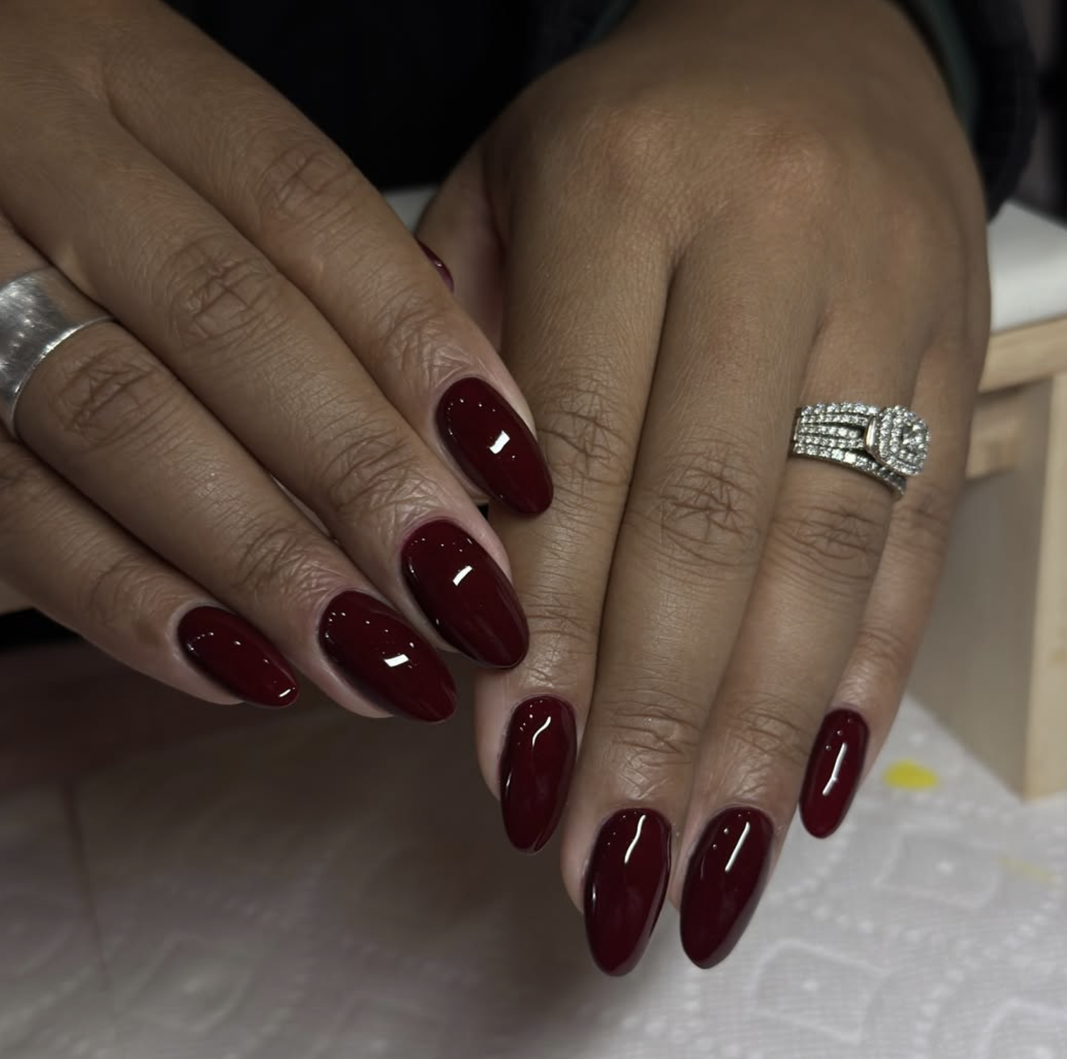 Deep wine red nail polish on natural short nails