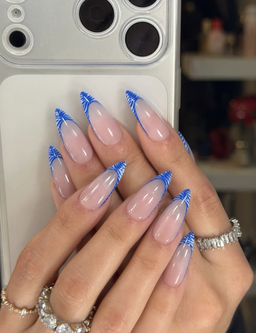 Nude nails with bright blue reverse French half-moons