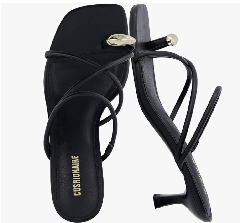A close-up of a black Cushionaire strappy kitten heel sandal featuring thin wrap-around straps and a modern square toe.