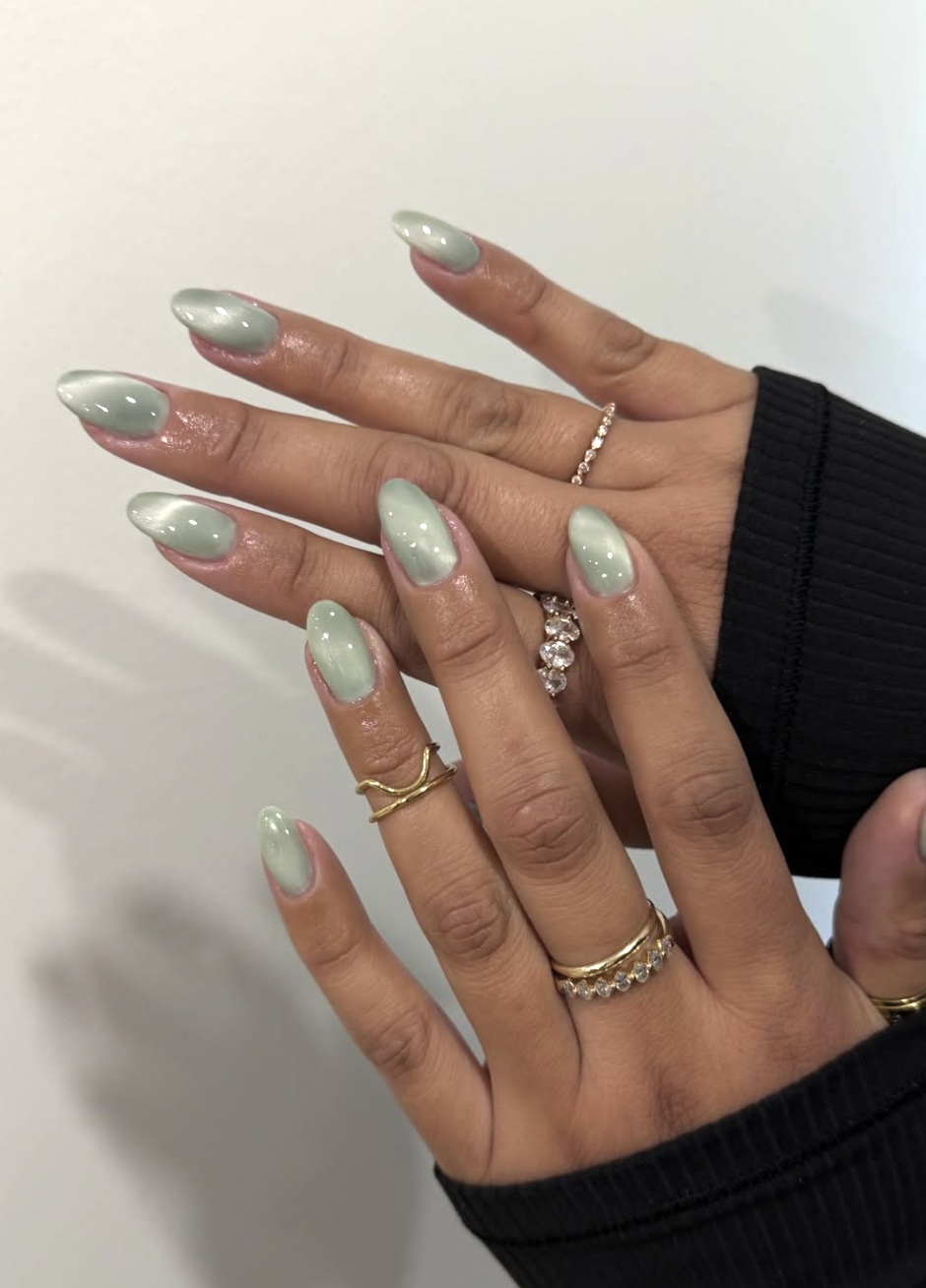 Long almond-shaped gel nails with a translucent, high-shine mint green jelly finish.