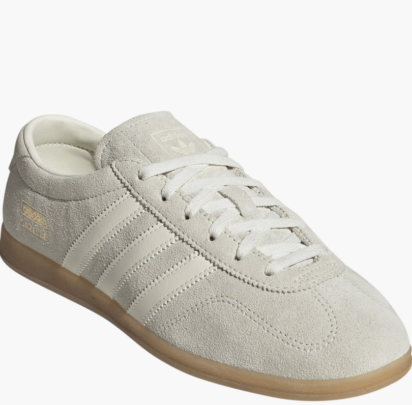 pair of neutral-toned adidas Gazelle Lo Pro Sneakers in light gray suede with a gum sole, representing minimalist and understated luxury footwear.