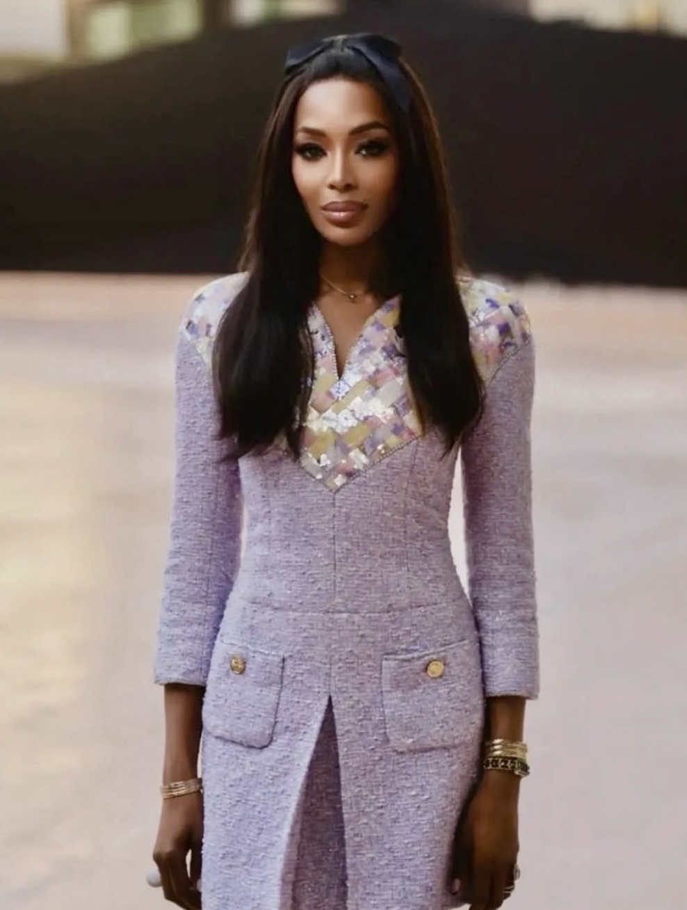Naomi Campbell wearing a cool lilac tweed suit, illustrating how jewel-toned pastels harmonize with a Deep Winter palette and cool-espresso skin tones.
