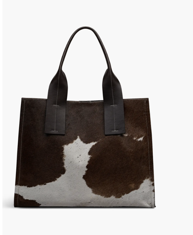 A large open-top shoulder bag by Radley London featuring a brown and white cowhide patterned body with solid dark brown leather handles and trim.
