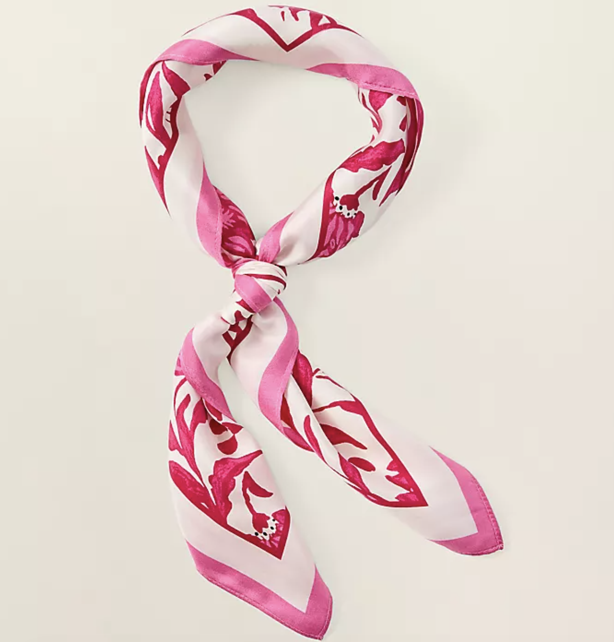Professional stylist's pick: a 100% silk Ann Taylor square scarf featuring a vibrant pink and white botanical floral print, styled in a classic neck loop.