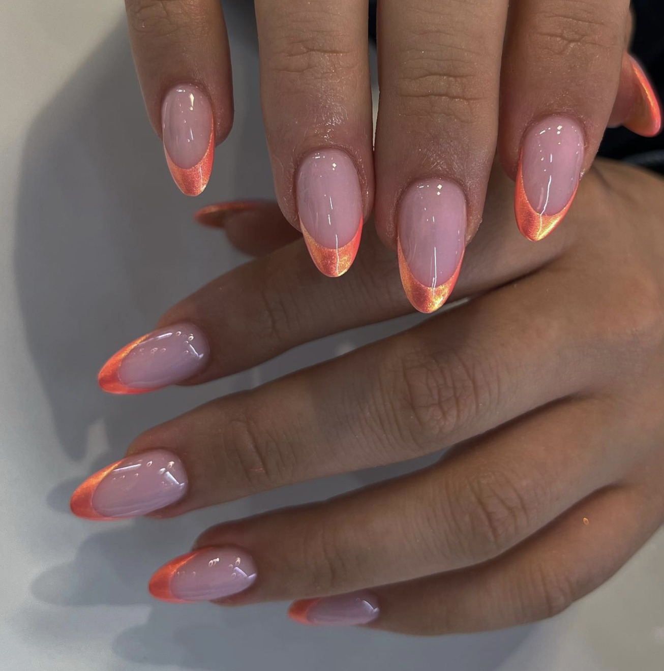 Almond nails with glossy coral French tips